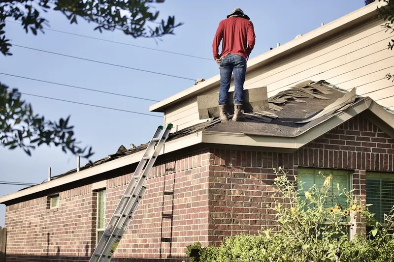 Professional roofer working on a residential roof in East Farmingdale